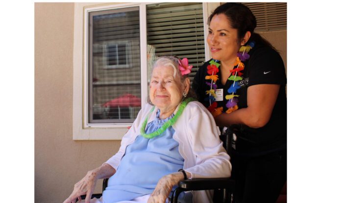 eldlery-woman-in-wheelchair-with-nurse