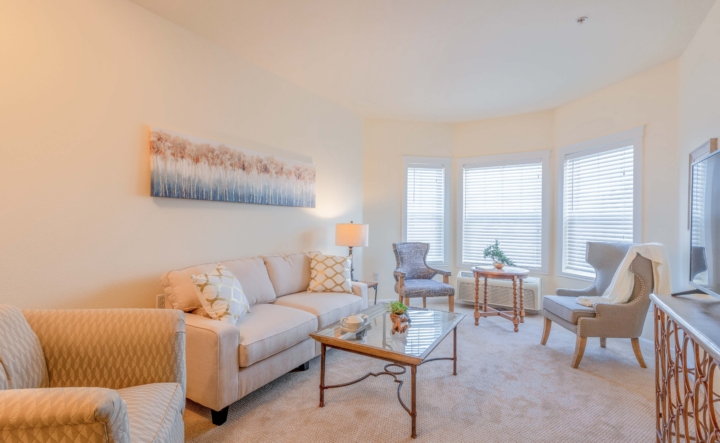 Living room area with couch and chairs