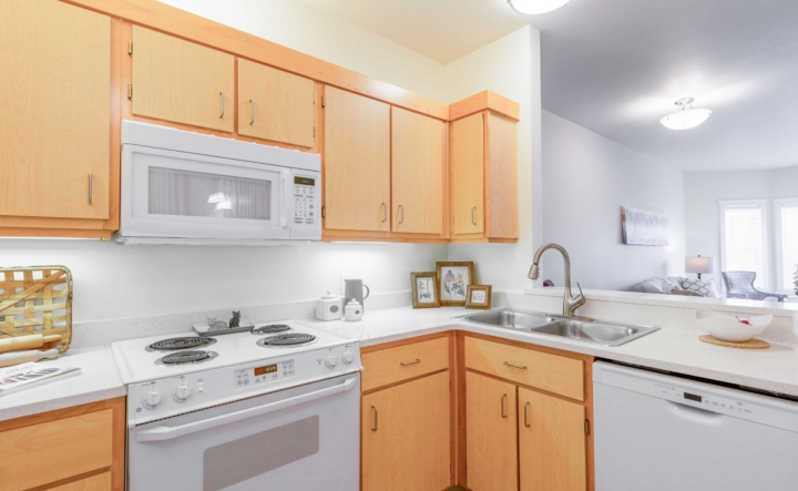 Kitchen with a microwave, stove, cabinets and sink