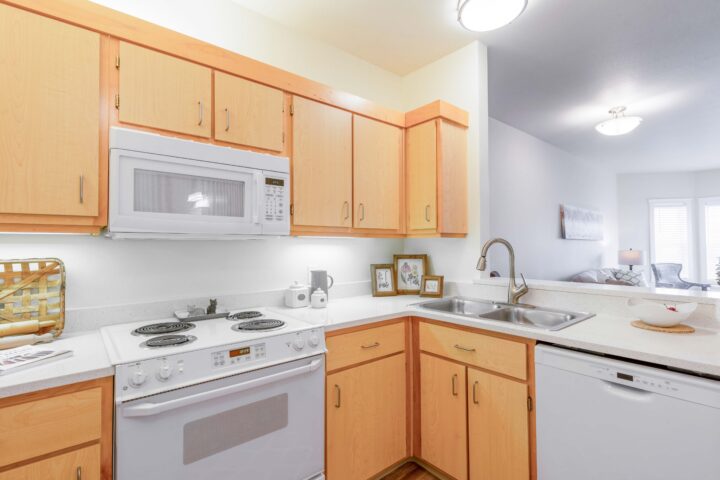 Kitchen with a microwave, stove, cabinets and sink