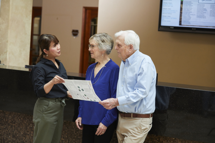 staff talking to couple about living options