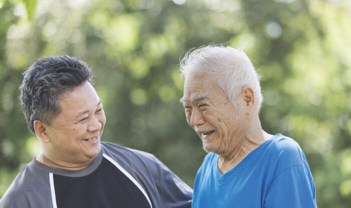 Two men smiling outside