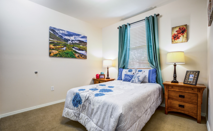 a full bed underneath a window