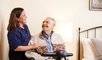man-in-wheelchair-smiling-at-nurse