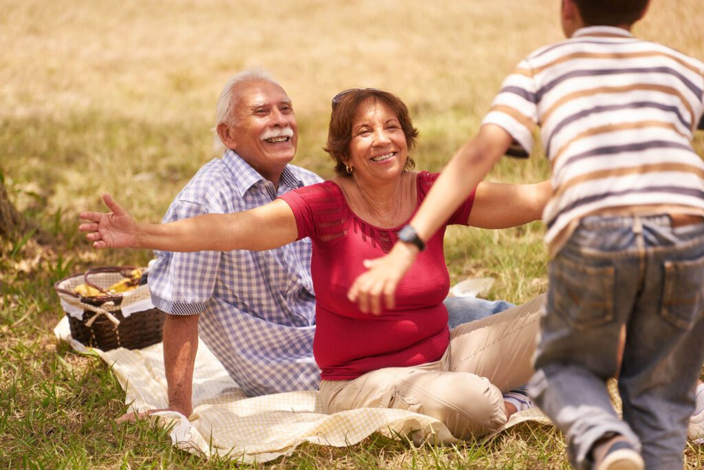 a family of 3 generations enjoys a picnic