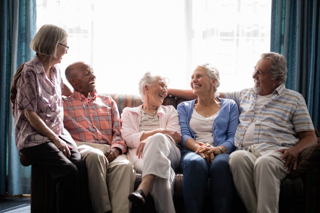 a group of elderly people enjoy each others company