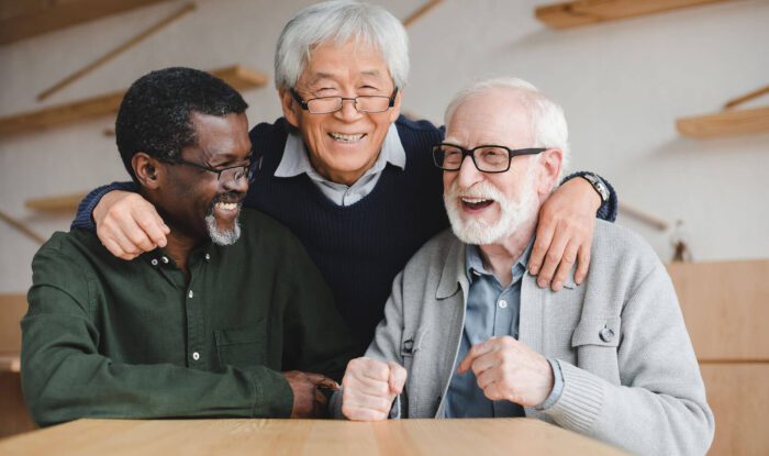 3 elderly men pose for a photo