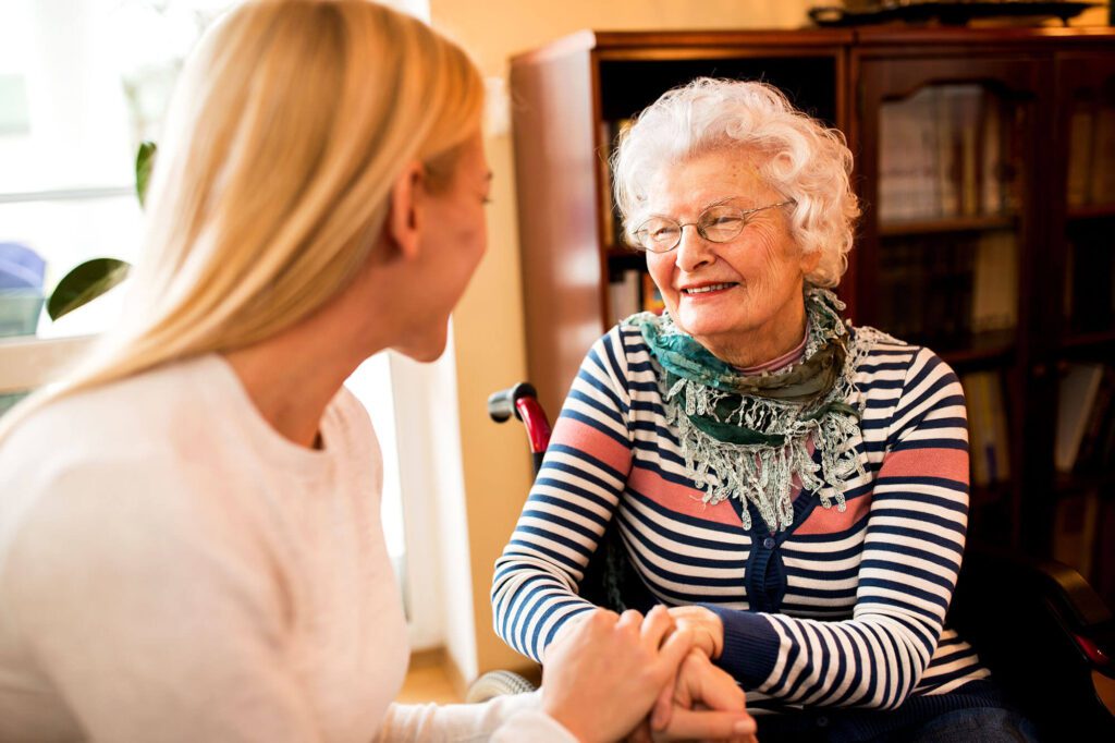 Caregiving: A grandma and granddaughter hold hands