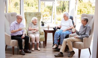 4 elderly woman sit in nice chairs and enjoy a conversation - Senior Living at Generations LLC