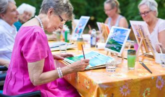 a group of elderly women painting