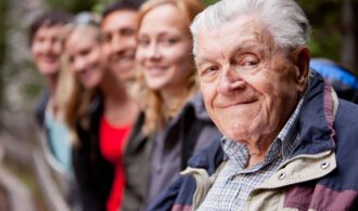 a man in assisted living smiles with his family