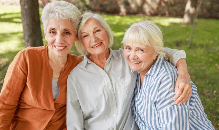 3 elderly woman pose for a photo together