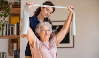 A nurse conducts physical therapy with a resident - Memory Care Generations LLC