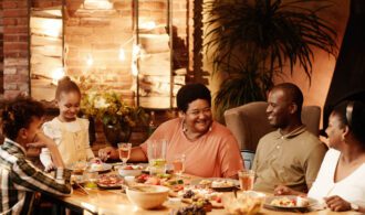 a family sits around a table and enjoys a meal together in senior living