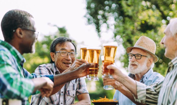 4 men cheers their beers