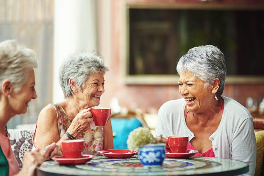 3 woman enjoy a meal and and a laugh