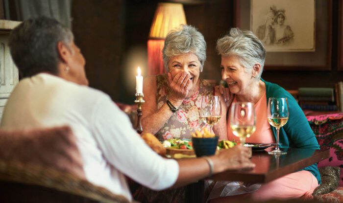 seniors enjoy a dinner party - Senior Living at Generations LLC