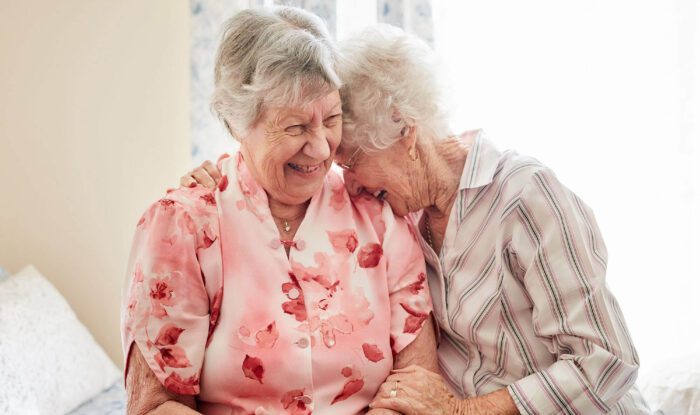 2 elderly women share an intimate moment