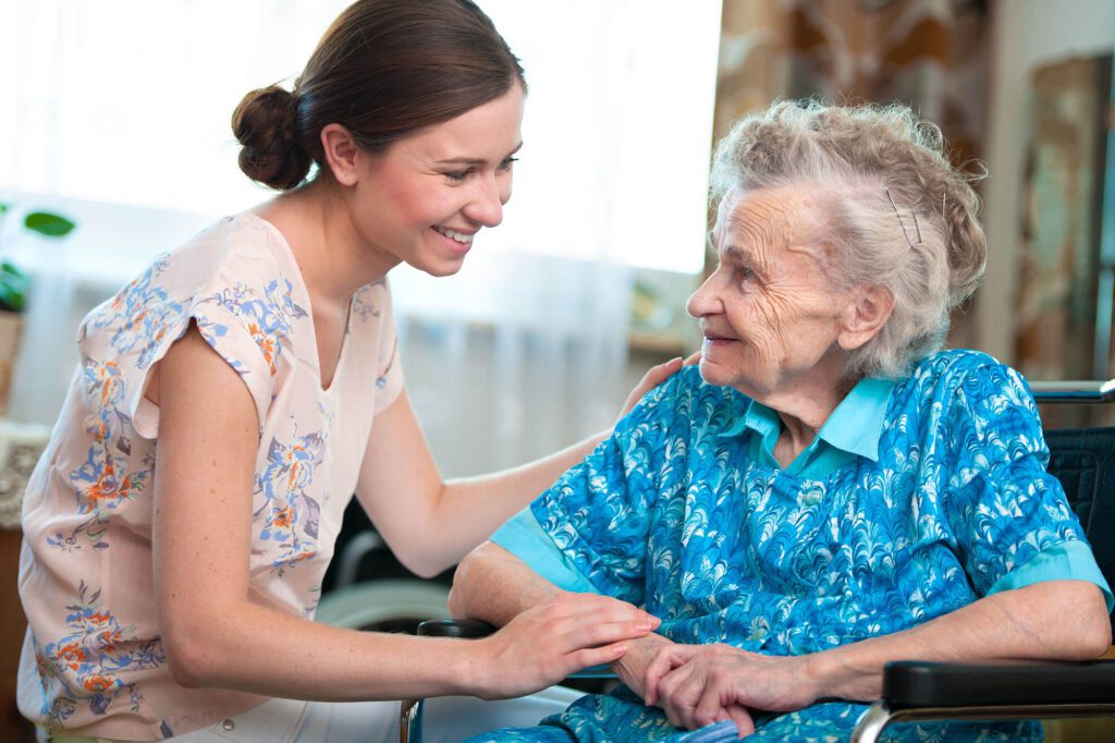 an elderly woman is cared for by a staff member