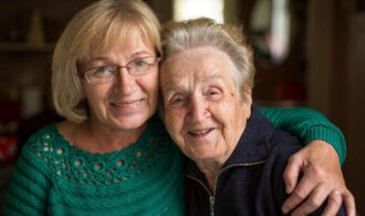 a mother and daughter share a huge and smile