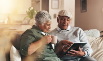 A couple sits on a couch at Generations Senior Living and memory care. Generations LLC
