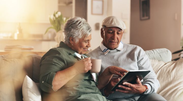 A couple sits on a couch at Generations Senior Living