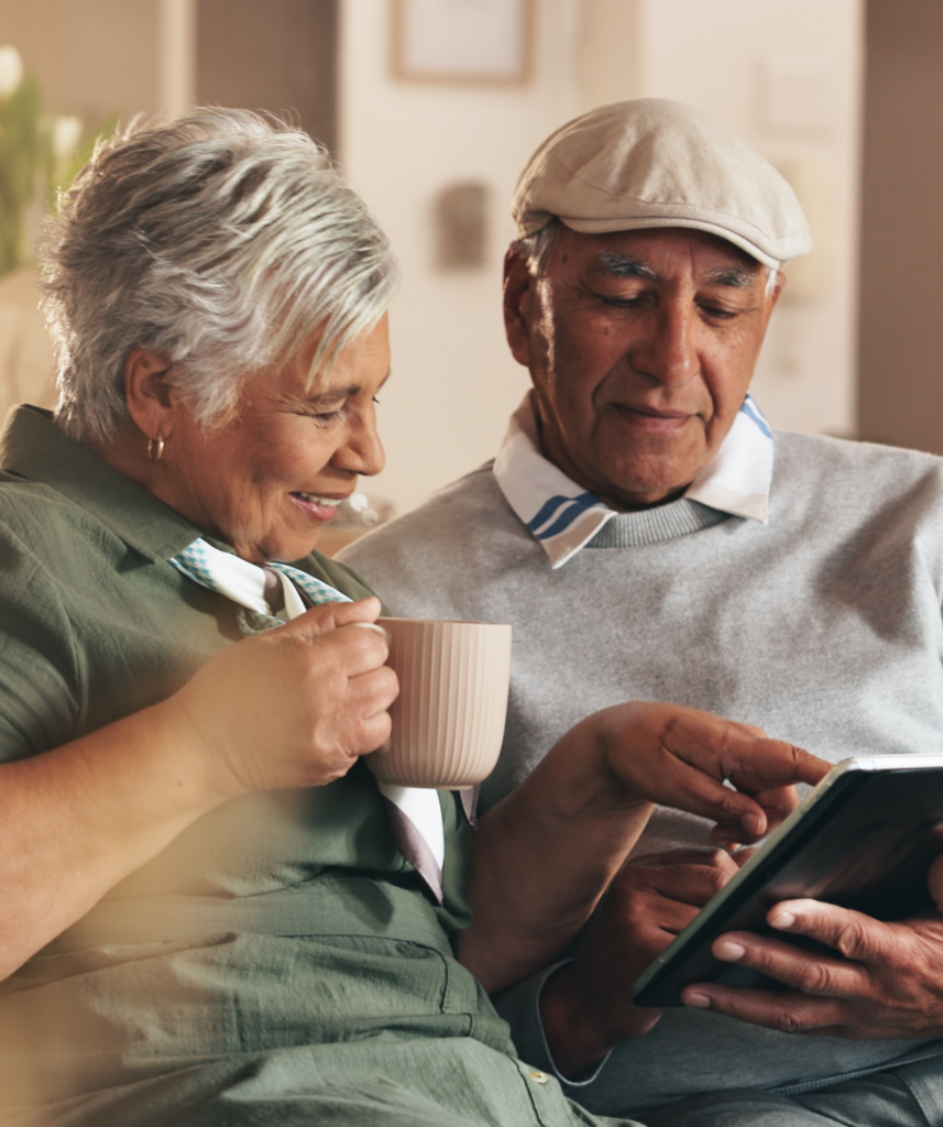 An elderly couple looks at Generations living options on the couch